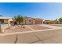 Delightful one-story home featuring low maintenance landscaping and a cozy entrance at 7849 E Golf Ave, Mesa, AZ 85209