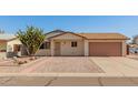 Inviting single-story home with a well-maintained front yard and attached garage at 7849 E Golf Ave, Mesa, AZ 85209