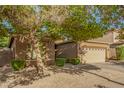 Inviting single-story home with a two-car garage and low maintenance desert landscaping at 8209 S 23Rd Pl, Phoenix, AZ 85042