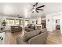Bright, open-concept living area with wood floors and views to the kitchen and dining areas at 8209 S 23Rd Pl, Phoenix, AZ 85042