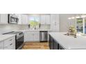 The recently renovated kitchen offers stainless appliances, white cabinets, and sleek countertops at 8326 E Crestwood Way, Scottsdale, AZ 85250