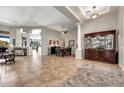 Spacious living room with tile floors, neutral walls, columns, ceiling fan and large windows with natural light at 9225 W Bajada Rd, Peoria, AZ 85383