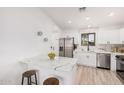 Modern kitchen features white cabinets, stainless steel appliances, and a marble island at 11025 E Cholla Rd, Mesa, AZ 85207
