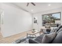 Bright living room features a large window, a door, and a comfortable seating area at 11025 E Cholla Rd, Mesa, AZ 85207