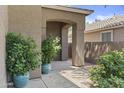 Welcoming front porch featuring potted plants and a covered entrance, enhancing the home's curb appeal at 1162 E Ranch Ct, Gilbert, AZ 85296