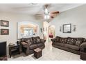 Spacious living room features tile floors, ceiling fan, and decorative archway at 12318 W Bloomfield Rd, El Mirage, AZ 85335