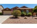 Inviting single-story home with desert landscaping, mature shrubs and a spacious driveway at 1247 E Bautista Rd, Gilbert, AZ 85297
