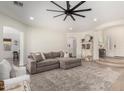 Bright living room features an open layout, a large sectional sofa, and a stylish ceiling fan at 1247 E Bautista Rd, Gilbert, AZ 85297