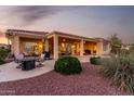 Inviting outdoor space with a covered patio, comfortable seating, and professionally designed desert landscaping at 13219 W Santa Ynez Dr, Sun City West, AZ 85375
