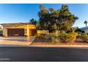 Single-story home with a tile roof, lush landscaping, and a three-car garage, basked in sunlight at 13219 W Santa Ynez Dr, Sun City West, AZ 85375