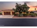 Inviting single-story home with a tile roof, lush landscaping, and a spacious three-car garage at 13219 W Santa Ynez Dr, Sun City West, AZ 85375