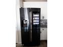 Stainless steel Samsung refrigerator with a built-in touchscreen at 1364 W Spine Tree Ave, Queen Creek, AZ 85140
