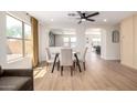Bright dining area with a glass-top table, comfortable chairs, and large windows at 13862 W Fargo Dr, Surprise, AZ 85374