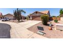 Charming desert home with a two-car garage, drought-tolerant landscaping, and a welcoming entrance at 13862 W Fargo Dr, Surprise, AZ 85374