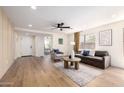 Inviting living room featuring a ceiling fan, comfortable seating, and lots of natural light at 13862 W Fargo Dr, Surprise, AZ 85374
