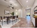 Bright dining room with a ceiling fan, decorative rug, and an open layout at 14572 W Medlock Dr, Litchfield Park, AZ 85340