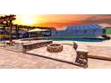 A backyard swimming pool features an outdoor fire pit and a beautiful pergola with seating at 16210 W Durango St, Goodyear, AZ 85338