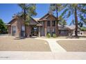 Traditional brick home with well-kept landscaping, a cozy entrance and an attached three-car garage at 1750 E Mallory St, Mesa, AZ 85203