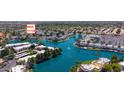 Aerial view showcasing waterfront condo community with scenic lake, lush landscaping, and nearby shopping at 1825 W Ray Rd # 1119, Chandler, AZ 85224