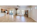 Open-concept living room features tile floors, sliding glass doors to a balcony, and a stone fireplace at 21320 N 56Th St # 1158, Phoenix, AZ 85054