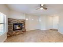 Comfortable living room with a stone fireplace and neutral decor; ceiling fan, tile floor and ample light at 21320 N 56Th St # 1158, Phoenix, AZ 85054