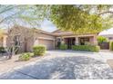 Inviting single-Gathering house showcasing a well-kept lawn, spacious driveway and desert landscaping at 2567 E San Isido Trl, Casa Grande, AZ 85194