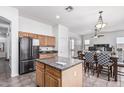 Open kitchen features stainless appliances, center island, and adjacent dining area, creating a social space at 26264 N 74Th Ln, Peoria, AZ 85383
