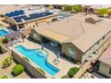 Aerial view of backyard with a private pool, covered patio, and solar panels at 27562 N 99Th Dr, Peoria, AZ 85383