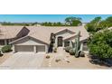 Charming home features a well-manicured desert front yard with a large, attached two-car garage at 29816 N 51St Pl, Cave Creek, AZ 85331