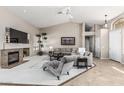 Open-concept living area with fireplace, plush seating, tall ceilings and neutral color scheme at 29816 N 51St Pl, Cave Creek, AZ 85331