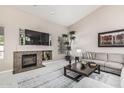 Bright living room showcasing a fireplace, neutral decor, large TV, and tall ceilings at 29816 N 51St Pl, Cave Creek, AZ 85331
