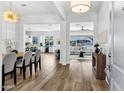 Inviting foyer with wood floors leading to open-concept living spaces and designer lighting at 3038 E Longhorn Dr, Gilbert, AZ 85297