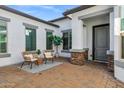 Charming front courtyard with a seating area, paver flooring, and stylish exterior finishes at 3038 E Longhorn Dr, Gilbert, AZ 85297