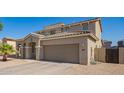 Home exterior showcasing desert landscaping and a spacious two-car garage at 36179 W Cartegna Ln, Maricopa, AZ 85138
