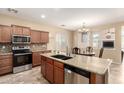 Kitchen featuring stainless steel appliances and a center island at 36179 W Cartegna Ln, Maricopa, AZ 85138