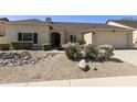 Charming single-story home showcasing desert landscaping, gravel yard, mature plants and covered entryway at 4137 W Cielo Grande --, Glendale, AZ 85310