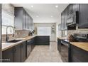 Spacious kitchen with dark cabinets, butcher block counters, stainless steel appliances, and lots of natural light at 4137 W Cielo Grande --, Glendale, AZ 85310