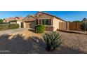 Well-maintained single-story home with desert landscaping and a private fenced yard at 42067 W Anne Ln, Maricopa, AZ 85138