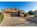 Inviting single-story home showcasing desert landscaping, a two-car garage, and neutral colors at 42067 W Anne Ln, Maricopa, AZ 85138