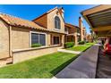Charming condo featuring well-kept lawns, desert landscaping, assigned parking, and a unique barrel tile roof at 4601 N 102Nd Ave # 1116, Phoenix, AZ 85037