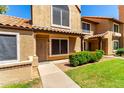Inviting two-story home featuring a well-maintained lawn and desert-friendly landscaping, exuding charm at 4601 N 102Nd Ave # 1116, Phoenix, AZ 85037