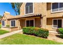 Inviting two-story home featuring a well-maintained lawn and desert-friendly landscaping, exuding charm at 4601 N 102Nd Ave # 1116, Phoenix, AZ 85037