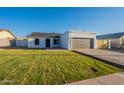 Charming home features a well-manicured lawn, neutral color palette, and a two-car garage at 4855 E Gary St, Mesa, AZ 85205