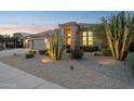 Desert home with a tile roof, three-car garage, desert landscaping, and walkway at 4960 E Dale Ln, Cave Creek, AZ 85331