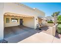 Inviting exterior showcasing a covered carport, shaded front patio, and charming curb appeal at 5209 N 78Th St, Scottsdale, AZ 85250