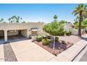 Expansive front yard with desert landscaping, complemented by a covered patio and desert landscaping at 5209 N 78Th St, Scottsdale, AZ 85250