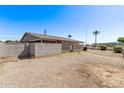 This property boasts a backyard with gravel, block fencing, and mature landscaping at 5902 W Orange Dr, Glendale, AZ 85301