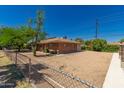 Spacious backyard with low-maintenance gravel landscaping, fenced perimeter, and brick accents at 6100 N 36Th Ave, Phoenix, AZ 85019