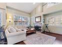 Inviting living room with a fireplace, large windows, and plush seating at 67 W Sarah Ln, Tempe, AZ 85284