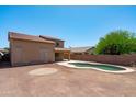 Spacious backyard with pool, patio, and block fence at 6944 S Morning Dew Ln, Buckeye, AZ 85326